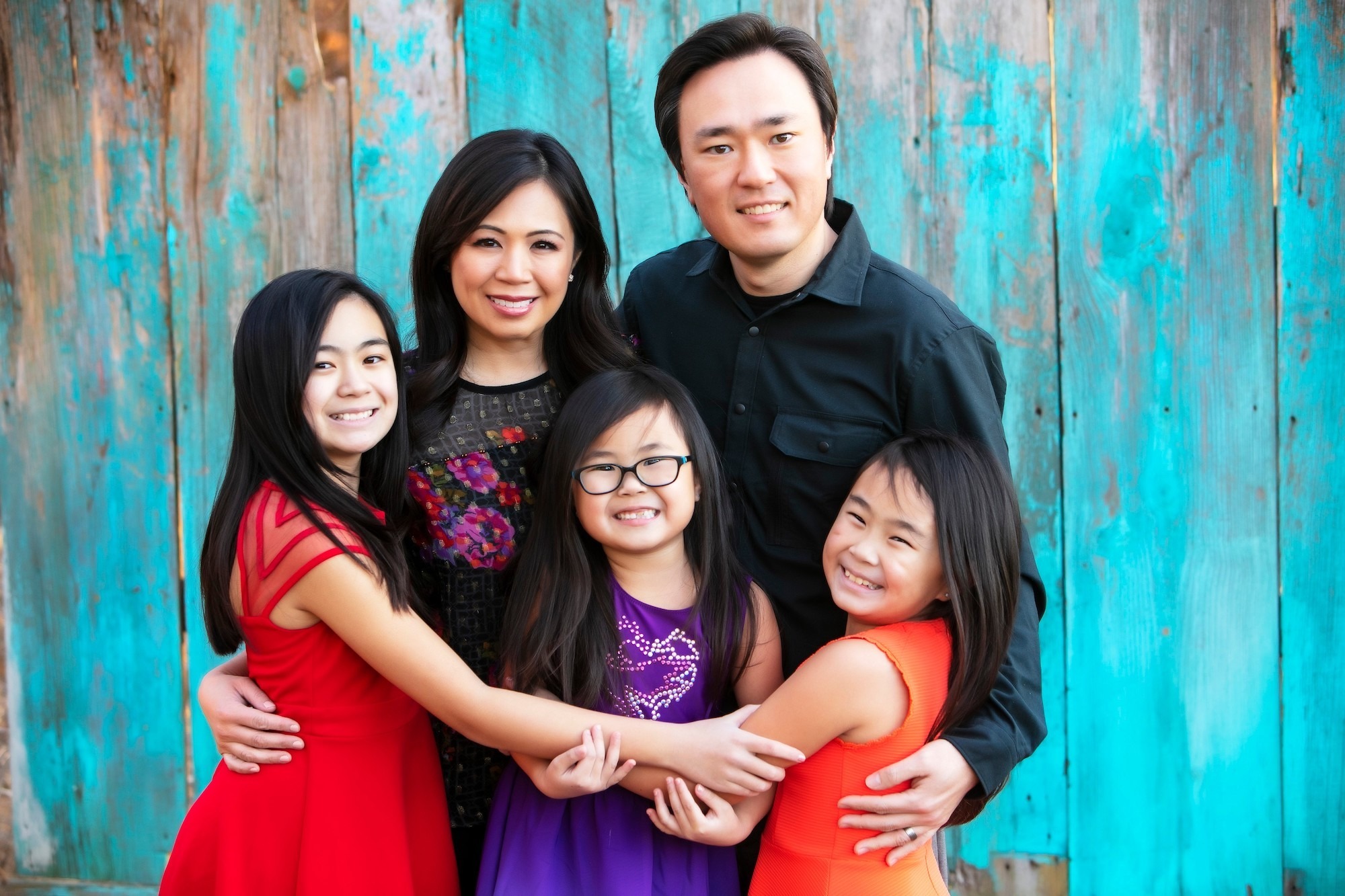 Family of five smiling together, showcasing a warm and friendly atmosphere, reflecting the family-friendly care at Moon Signature Dentistry in Olathe.