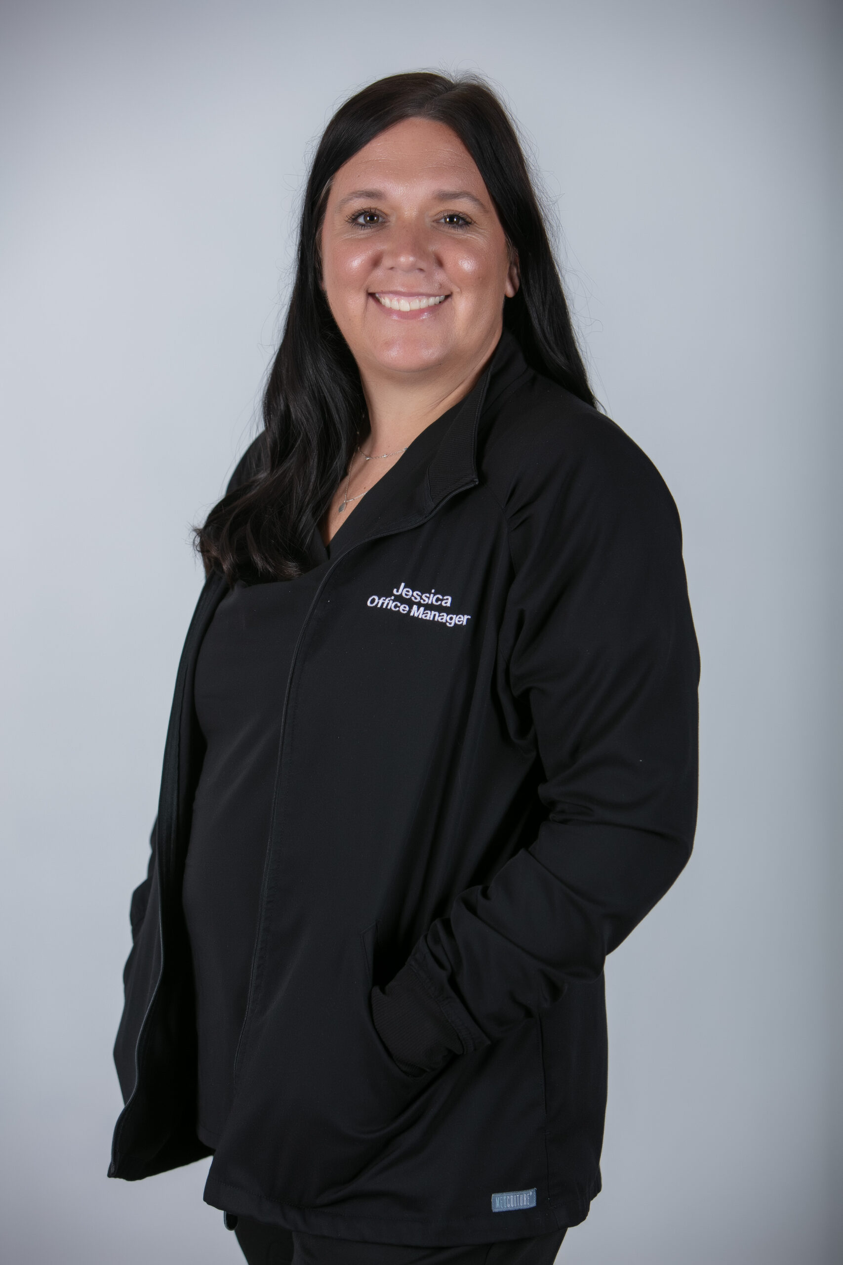 Jessica, Office Manager at Moon Signature Dentistry, smiling in a black jacket, highlighting her role in fostering patient relationships and team collaboration in Olathe's dental care.
