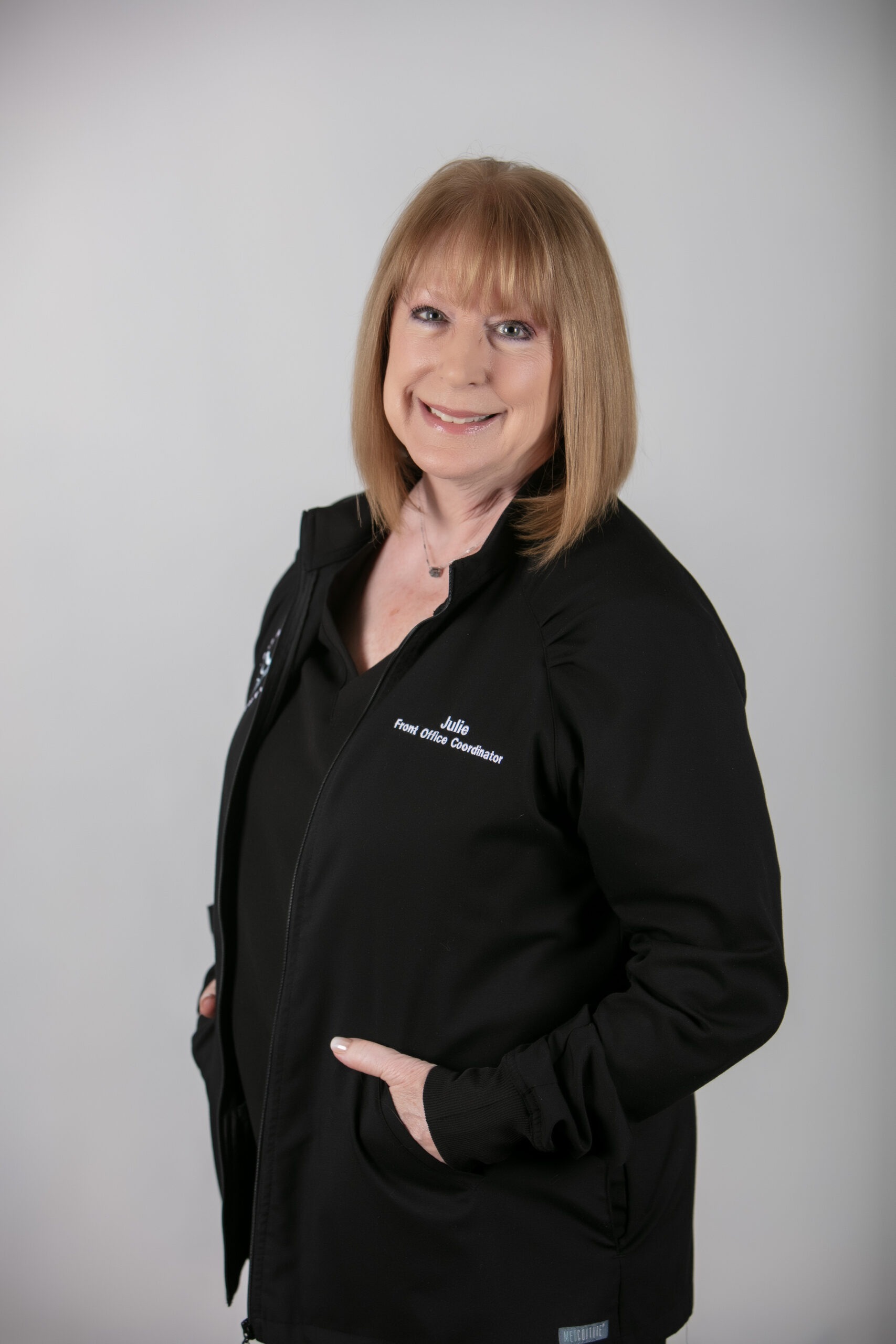 Julie, Front Office Coordinator at Moon Signature Dentistry, smiling in a black jacket, representing personalized care in Olathe family dentistry.