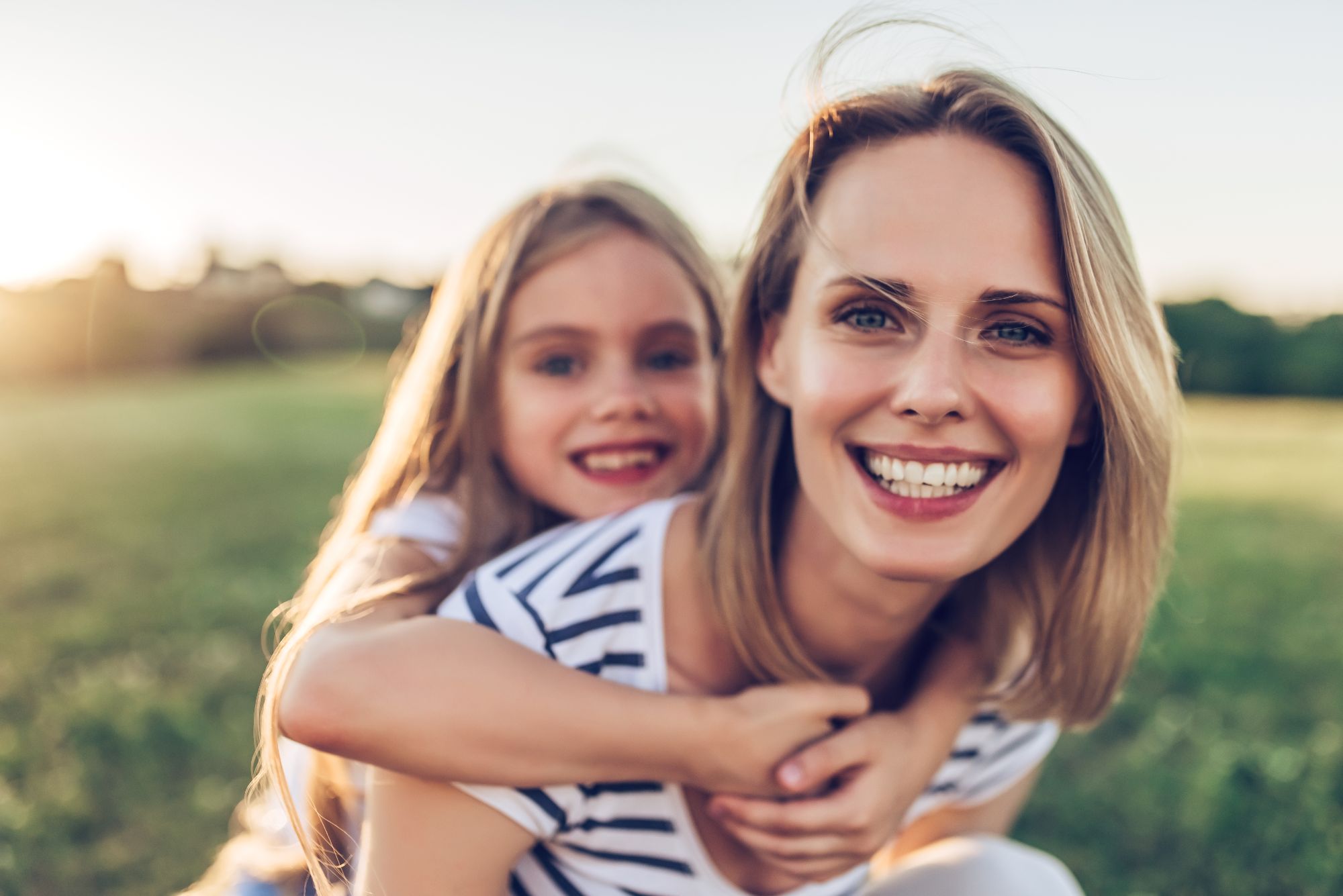 Woman with a restored smile from restorative dental services at Moon Signature Dentistry in Olathe